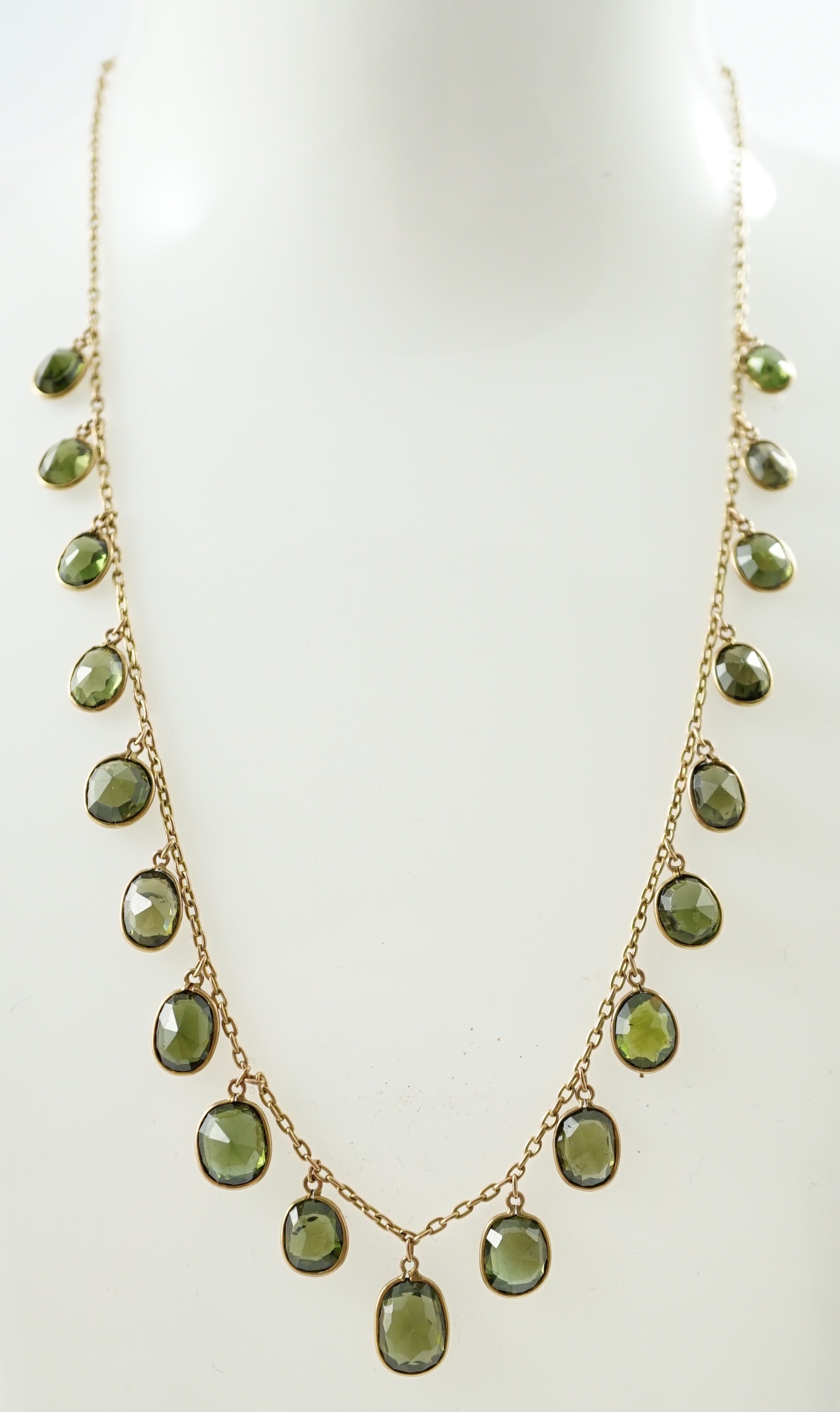 A late Victorian 15ct gold and graduated oval cut green tourmaline fringe choker necklace